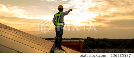 Engineer service check installation solar cell on the roof of factory.  136385587