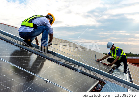 Engineer service check installation solar cell on the roof of factory. Engineer service check installation solar cell on the roof of factory. 136385589