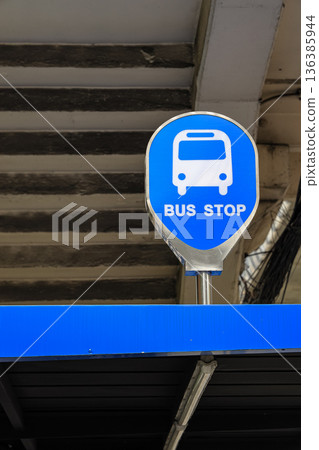 Bus stop sign n a rooftop in the old town area. indicating public transportation point in urban environment at daytime. Bus stop sign n a rooftop in the old town area. indicating public transportation point in urban environment at daytime. 136385944
