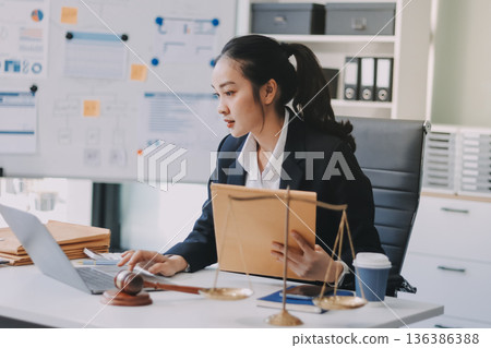 Lawyer explained to the client about the law that must be brought against the court case. Lawyer explained to the client about the law that must be brought against the court case. 136386388