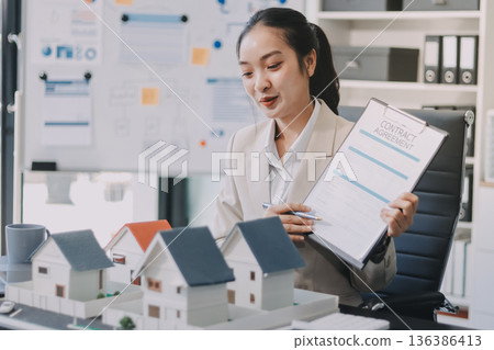 real estate agent home miniature model on documents sale and purchase of apartment notarial deed real estate agent home miniature model on documents sale and purchase of apartment notarial deed 136386413