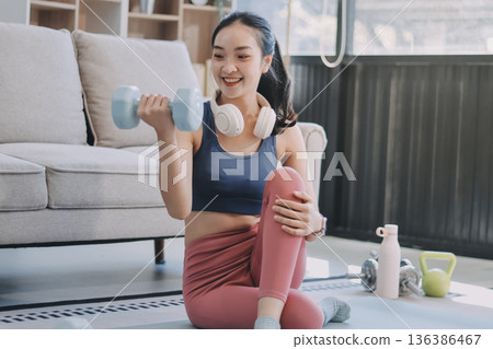 Young Asian sporty attractive people practicing yoga lesson with instructor. Asia group of women exercising healthy lifestyle in fitness studio. Sport activity, gymnastics or ballet dancing class. 136386467