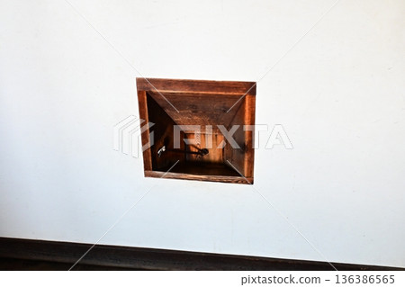 A wooden niche set into the white walls of the castle 136386565