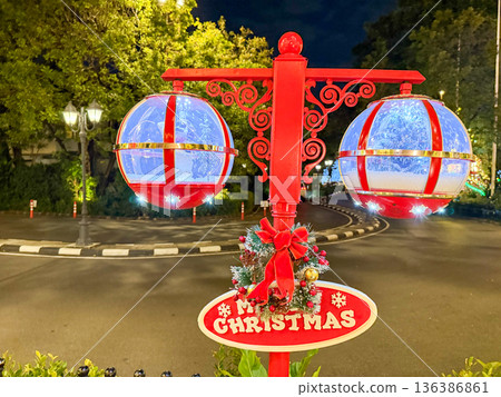 Festive Christmas street decoration with glowing lanterns at night Festive Christmas street decoration with glowing lanterns at night 136386861