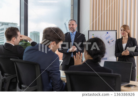 Diverse colleagues gather in brainstorm discuss statistics together. 136386926