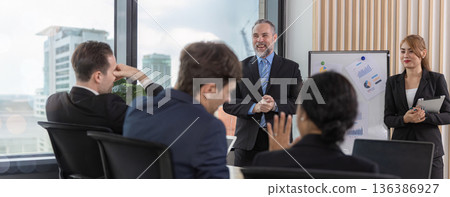 Diverse colleagues gather in brainstorm discuss statistics together. 136386927