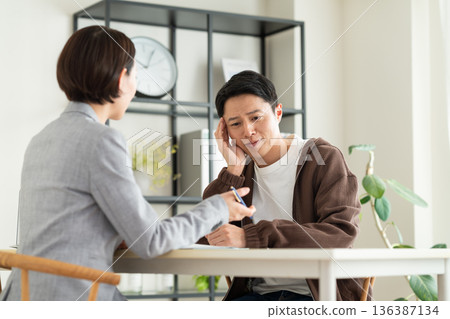 A middle-aged man consulting with a planner 136387134