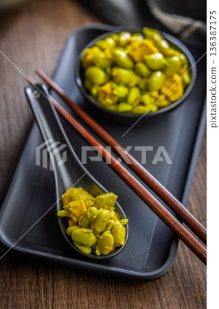 Fresh salad with edamame beans on ceramic spoon on wooden table. Fresh salad with edamame beans on ceramic spoon on wooden table. 136387175