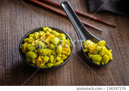 Fresh salad with edamame beans in bowl on wooden table. Fresh salad with edamame beans in bowl on wooden table. 136387176