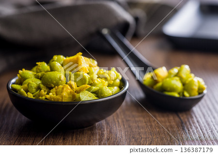 Fresh salad with edamame beans in bowl on wooden table. 136387179