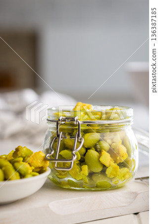 Fresh salad with edamame beans in jar on white table. 136387185