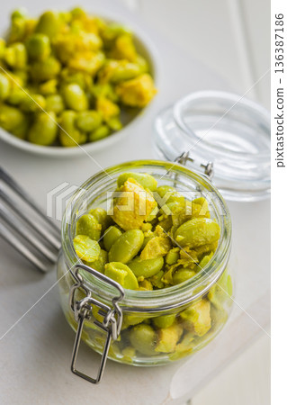 Fresh salad with edamame beans in jar on white table. Fresh salad with edamame beans in jar on white table. 136387186