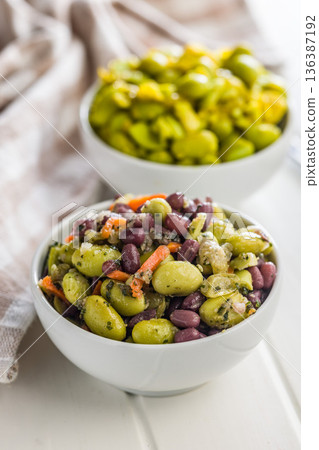 Fresh salad with edamame beans in bowl on white table. 136387192
