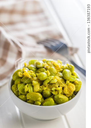 Fresh salad with edamame beans in bowl on white table. Fresh salad with edamame beans in bowl on white table. 136387193