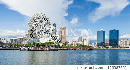 Panoramic view of the Kaohsiung Music Center and buildings along the harbor waterfront. The white hexagonal building structure on the shore of Love Pier. Panoramic view of the Kaohsiung Music Center and buildings along the harbor waterfront. The white hexagonal building structure on the shore of Love Pier. 136387231
