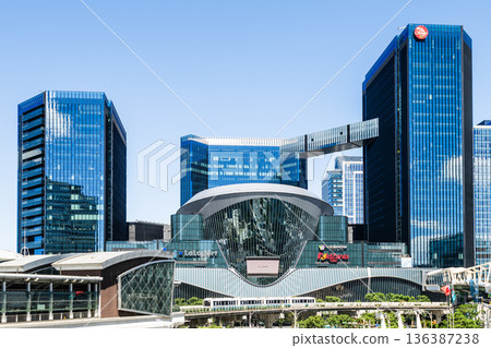 A train on the Wenhu or Brown Line of the Taipei MRT passes by the Mitsui Shopping Park LaLaport Taipei Nangang. 136387238