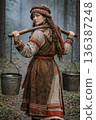 Young ethnic woman carrying water with yoke in forest 136387248