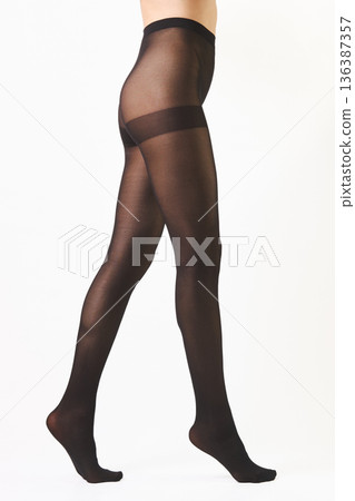 Unrecognizable woman walking on tiptoes in sheer butt lifting pantyhose isolated on white background Unrecognizable woman walking on tiptoes in sheer butt lifting pantyhose isolated on white background 136387357