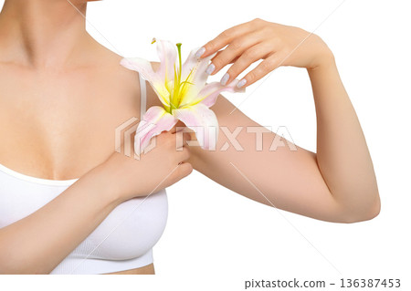 Woman with lily flower on grey background, closeup. Skin care concept Woman with lily flower on grey background, closeup. Skin care concept 136387453