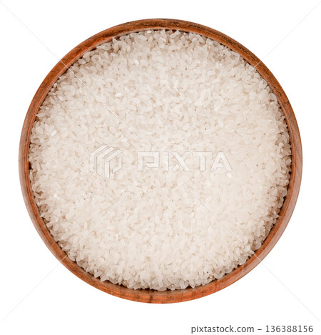 Rice cereal in a brown wooden bowl isolated on white background 136388156