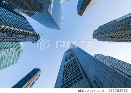 Low-angle building view of the modern office skyscrapers in the financial district of Raffles Place, Singapore. Low-angle building view of the modern office skyscrapers in the financial district of Raffles Place, Singapore. 136388282