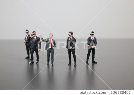 Miniature Business Figures Walk Together In Corporate Scene 136388402