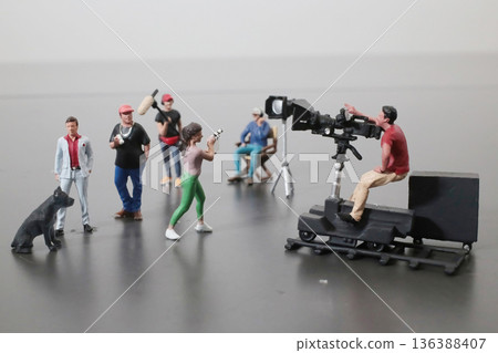 Miniature Film Crew Shoots Scene With Figures And Dog 136388407