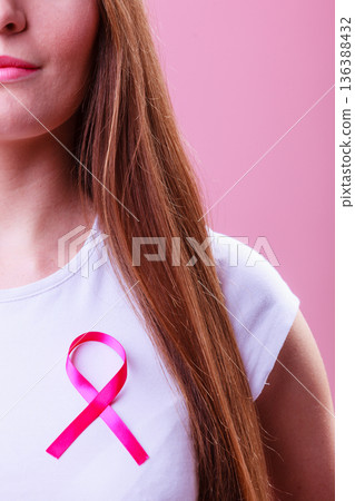Woman wih pink cancer ribbon on chest Woman wih pink cancer ribbon on chest 136388432