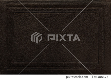 Vintage book cover. Dark leather texture with embossed rectangular frame and subtle grain detail. Natural mockup, background with copy space 136388674