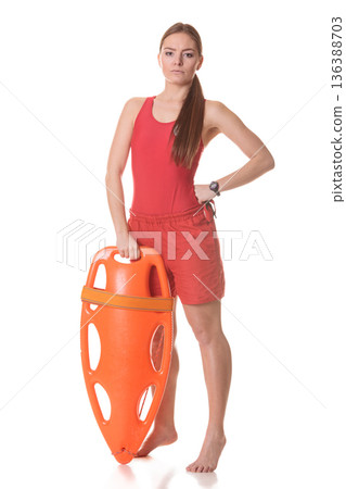 Lifeguard on duty with rescue buoy supervising. Lifeguard on duty with rescue buoy supervising. 136388703