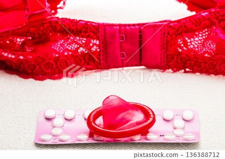Pills and condom with lace lingerie. 136388712