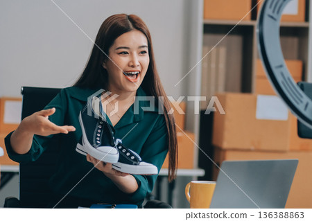 Starting small businesses SME owners female entrepreneurs check online orders to prepare to pack the boxes, sell to customers, sme business ideas online. 136388863