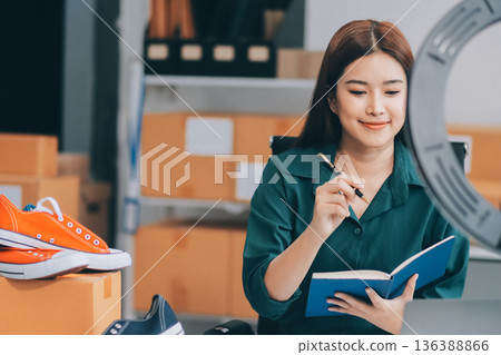 Starting small businesses SME owners female entrepreneurs check online orders to prepare to pack the boxes, sell to customers, sme business ideas online. Starting small businesses SME owners female entrepreneurs check online orders to prepare to pack the boxes, sell to customers, sme business ideas online. 136388866