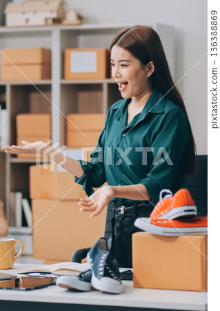 Starting small businesses SME owners female entrepreneurs check online orders to prepare to pack the boxes, sell to customers, sme business ideas online. 136388869