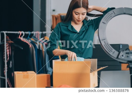 Starting small businesses SME owners female entrepreneurs check online orders to prepare to pack the boxes, sell to customers, sme business ideas online. Starting small businesses SME owners female entrepreneurs check online orders to prepare to pack the boxes, sell to customers, sme business ideas online. 136388876