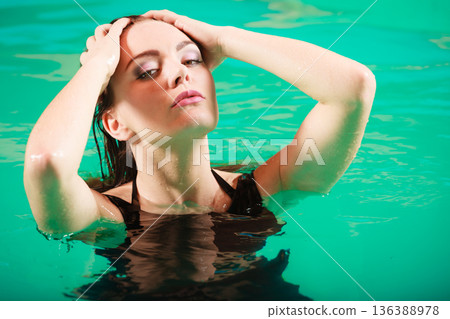 Sexy seductive woman in black dress in water. Sexy seductive woman in black dress in water. 136388978