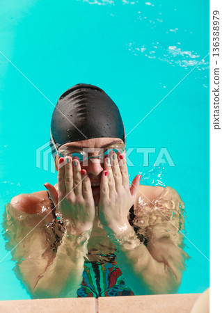 Woman athlete in swimming pool water. Sport. 136388979