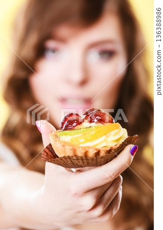 Cupcake cake in woman hand. Sweet food. Cupcake cake in woman hand. Sweet food. 136388986