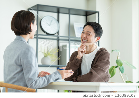 A middle-aged man consulting with a planner A middle-aged man consulting with a planner 136389102