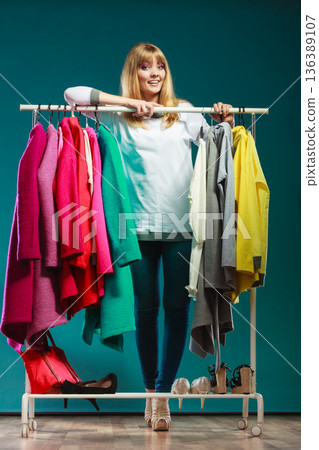 Woman choosing clothes in mall or wardrobe 136389107