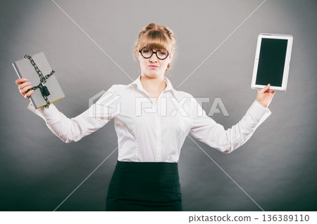 Woman with document and tablet. Digital storage. 136389110