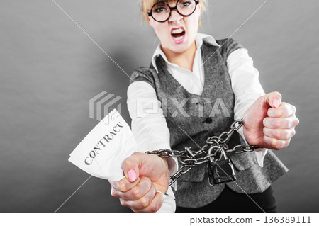 Furious woman with chained hands and contract 136389111