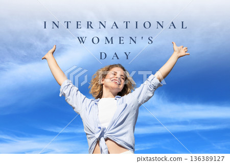 Woman celebrates International Women's Day with arms raised Woman celebrates International Women's Day with arms raised 136389127