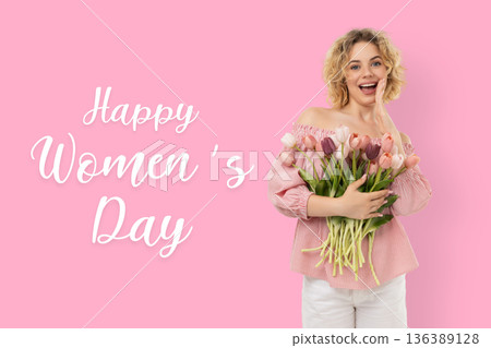 A woman holds flowers while celebrating Women's Day A woman holds flowers while celebrating Women's Day 136389128