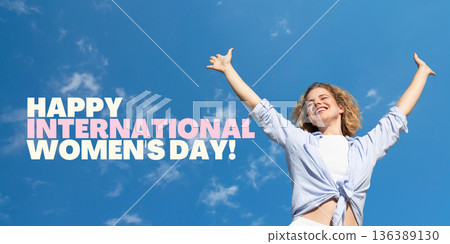 A woman joyfully celebrates Women's Day under a bright sky A woman joyfully celebrates Women's Day under a bright sky 136389130