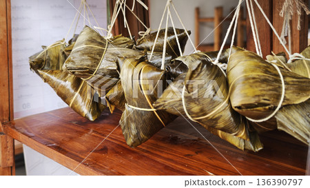 Zongzi, an ancient Chinese traditional dish wrapped in fragrant leaves, crafted with fine ingredients and cherished in cultural festival rituals. 136390797