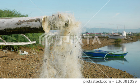 Sea sewing white fishing net mesh hang on boat to dry improvised trap Cebu Philippines equipment tools, capture aquatic creatures like fish, crabs, shellfish nylon polyethylene, cotton to secure food 136391059