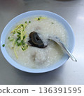Thai rice porridge or Congee topped with preserved century egg, ginger, and spring onions in a bowl 136391595