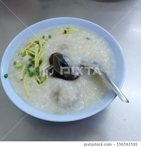 Thai rice porridge or Congee topped with preserved century egg, ginger, and spring onions in a bowl Thai rice porridge or Congee topped with preserved century egg, ginger, and spring onions in a bowl 136391595