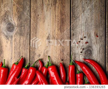 Ripe red chili peppers on wooden table, flat lay. Space for text Ripe red chili peppers on wooden table, flat lay. Space for text 136393265